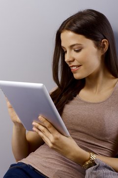 Young brunette with tablet pc