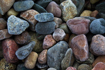 Multi-colored stones in the frost covered with hoarfrost