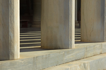 elements of marble columns and steps along with shadows on a sunny day