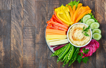 Hummus platter with assorted vegetable snacks. Healthy vegan and vegetarian food. Top view, flat...