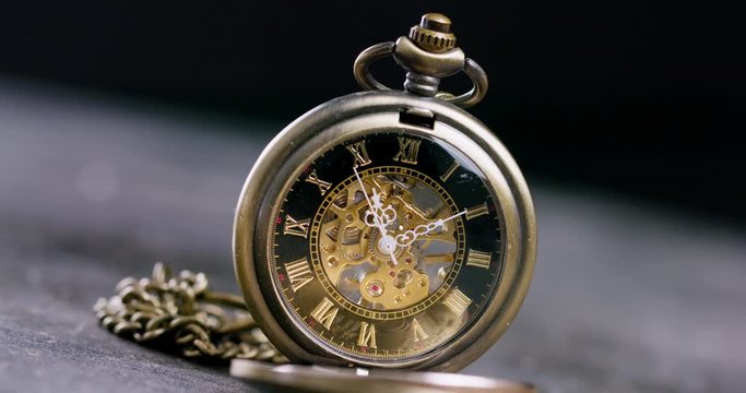 Antique old pocket watch dial close-up. Vintage hipster clock measuring time.