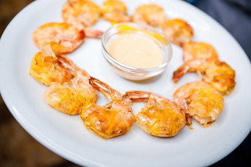 King prawns in a creamy sauce on a dish. 
