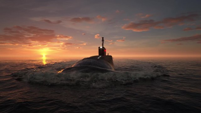 Submarine floating in ocean at sunset