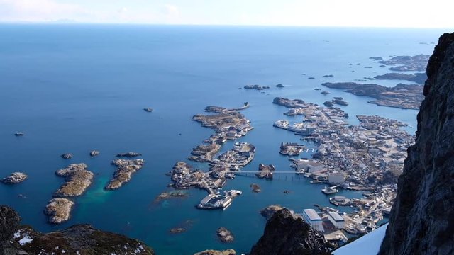 View from Svolvaergeita down to Svolvaer with a pan up and rocks in the foreground