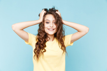 Fototapeta premium Surprised and amazed young woman isolated over the blue background