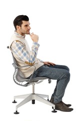 Side view of young man in swivel chair