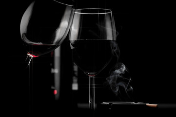 Clinking glasses of red wine on black background