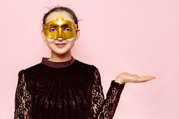 Portrait of beautiful woman in evening dress and golden masquerade mask. Valentines day, Carnival,...