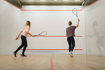 Fototapeta na wymiar Two female players with rackets, squash game