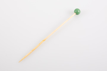 Natural wooden toothpicks green ball  isolated on white background