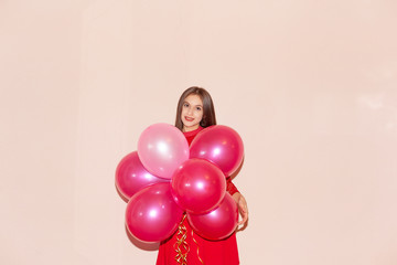 attractive and young woman holds balloons. valentines day, birthday, womens day, anniversary, holiday celebration concept