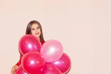 young  and beautiful girl holds air balloons. valentines day, birthday, womens day, anniversary, holiday celebration concept
