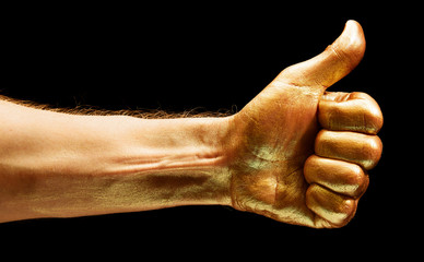 Image of gold painted Like gesture on black background