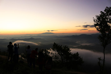 Beautiful scenery of mountain with mist sea, golden light shines on sky and sunrise up from the horizon at view point of Phu chi phoe in the early morning, Khun Yuam, Mae Hong Son, Thailand.  On Nov 1