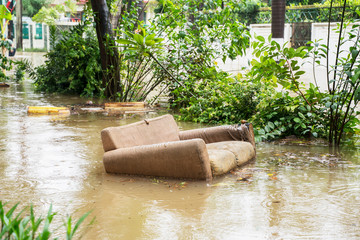 Sofa carried away flood stream in Jakarta city