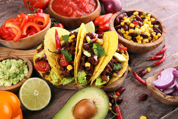 Mexican tacos with beef, tomatoes, avocado, chilli and onions. Handmade tortilla with pork