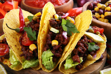 Mexican tacos with beef, tomatoes, avocado, chilli and onions. Handmade tortilla with pork