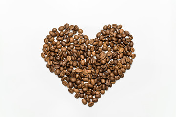  Heart laid out from coffee beans on a white background