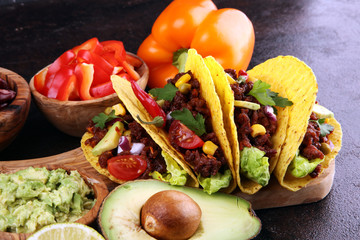 Mexican tacos with beef, tomatoes, avocado, chilli and onions. Handmade tortilla with pork