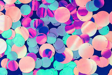 Big round holographic sequins abstract colorful background.