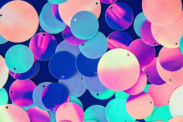 Big round holographic sequins abstract colorful background.