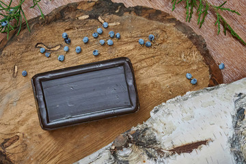 a bar of soap on a wooden table, top view. Natural soap