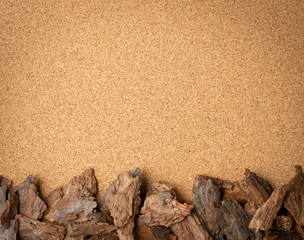 Fototapeta na wymiar Line of Pine Tree Bark Chip on Brown Cork Board Background