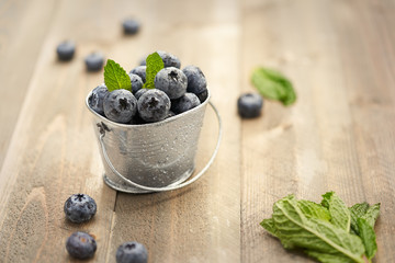 fresh blueberries in a bowl on wooden table