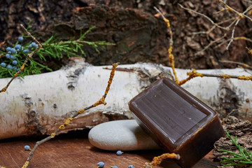 a bar of soap on a wooden table. Natural soap