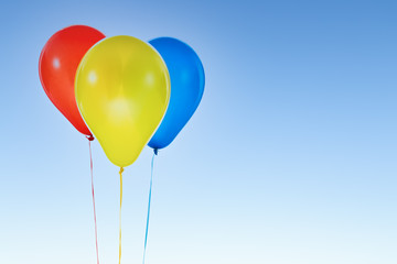 Fototapeta na wymiar Colorful balloons for birthday and celebrations isolated at blue sky