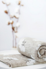 A rolled up knit plaids. The plaid has a pattern in the shape of white cotton boxes. Jacquard.