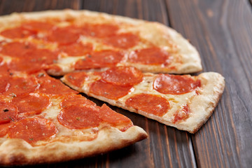 tasty pizza on the wooden background