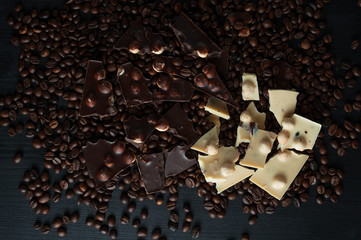 Coffee beans with chocolate Broken slices of chocolate fried coffee grains background