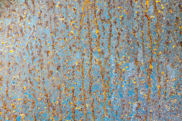 Rusty metal wall with cracked paint, background texture