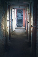 Basement long corridor with old rusty metal doors