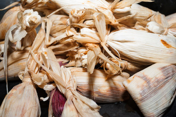 Group of tamales called Chuchitos in Guatemala, typical dish made with corn dough, sauce and chicken or pork meat.