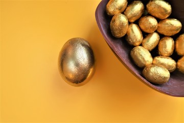 Golden chocolate Easter eggs  with copy space