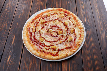 tasty pizza on the wooden background