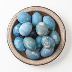 Fototapeta na wymiar Aquamarine easter eggs in ceramic bowl isolated on white