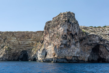 Fototapeta na wymiar rocks in the sea. Mountain slopes on the background of the sea shore. Seascape with mountain landscape. Photo of a sea landscape.