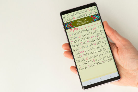 Reading Koran on the smart phone application.
