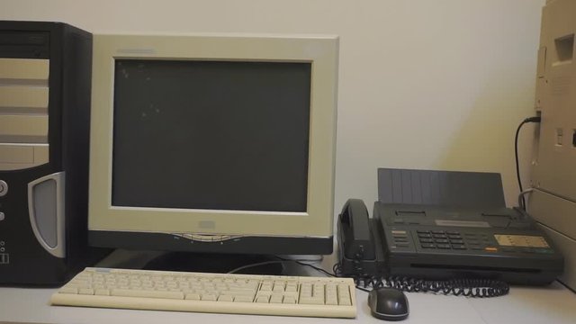 Old office and office equipment. Old desktop computer, old office phone and old copy machine