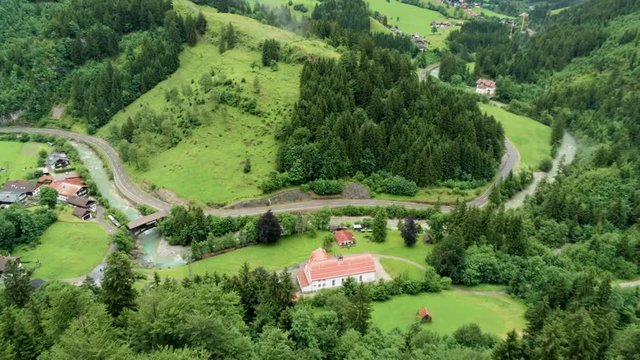 Aerial View of Countryside Village in Alps Mountains with River. Agriculture and Ecotourism in Hinterstein, Germany. 4K Drone Fly over Background Shot