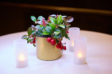 White electric candles stand on the dinner table