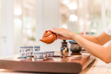Chinese tea ceremony is perfomed by tea master. Professional hands of a tea master are cooking show a tea ceremony. White Chinese tea.