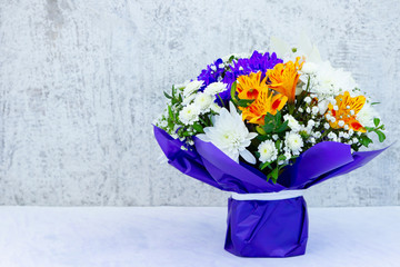 Bouquet of wildflowers on Valentine's Day. Bunch of alstroemeria flowers in the classic blue wrapper. Festive bouquet of flowers with copy space