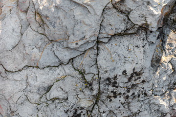 The texture of the stone with cracks in gray. Background image for text