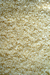 food background of white round rice. selective focus
