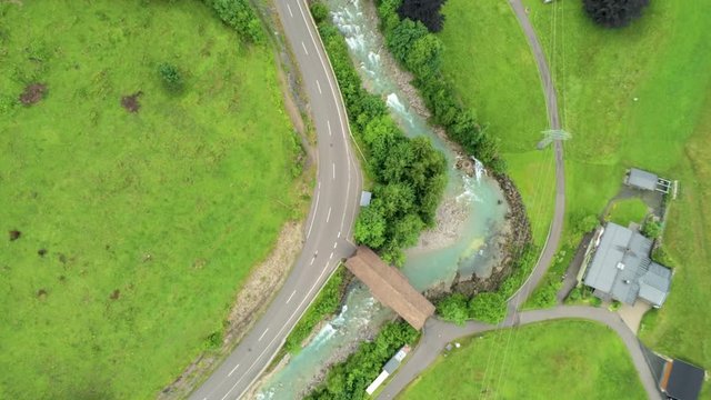 Aerial View of Countryside Village in Alps Mountains with River. Agriculture and Ecotourism in Hinterstein, Germany. 4K Drone Fly over Background Shot