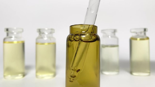 Close up CBD pipette.  Bottle of Cannabis oil. Oil bottles on white background. Medical cannabis concept. Spruce cbd oil. Oil cbd stock images 
